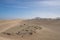 Several cars on the road in the sand dunes