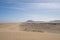 Several cars on the road in the sand dunes