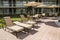 Several chairs with a parasol for sunbathing by the pool. Florid