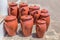 Several clay pots on floor outside pottery