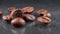 Several coffee beans on a gray background. Close-up.