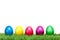 Several Colorful Easter eggs on a green meadow