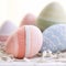 Several colorful eggs are sitting on a white table, AI