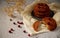 Several cookies on a ceramic plate with cranberries and dried flowers in the backgroundSeveral cookies on a ceramic plate with