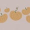 several cute autumn orange pumpkins with green roots on a beige background. the concept of autumn atmosphere and coziness