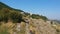 Several cyclists ride on mountain ruins.