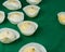 Several and Delicious French dessert Meringues into a silicone form moulds on green tablecloth