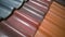 Several diagonal rows of multicolored clay roof tiles for sale in German store