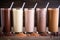 several different chocolate milkshake types aligned in a row