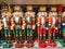 Several different nutcraker soldiers toys displayed in a store, christmas decoration for sale in market Happy New Year