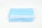 Several disposable surgical face masks to cover the mouth and nose and prevent coronavirus. White background. Healthcare or