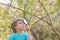 Several Easter colored eggs hanging on a tree branch color sunny spring day.