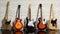Several electric guitars on a brick wall background