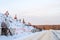 Several excavators work on a huge mountain in a garbage dump