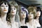 Several female mannequins with wigs