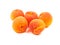 Several five group ripe orange apricots, peaches isolated on whi