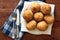 Several freshly fried, traditional Sicilian rice balls with filling arancini siciliani are photographed from above on a rustic