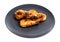 Several fried tiger prawns on black plate isolated