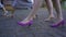 Several girls step forward synchronously in high-heeled shoes. Legs close.