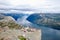 Several hikers enjoying the views in the summit of the Pulpit Rock Preikestolen, Norway.