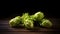 Several hops cones arranged in a pattern on a dark background, with their unique spiky shape and green color.