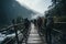 Several individuals are seen walking across a wooden bridge, connecting two parts of a scenic landscape, Group of trekkers cross