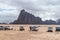 Several jeeps and their drivers are waiting for tourists near Wadi Rum Visitor Center at the entrance to Wadi Rum desert near Aqab