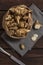 Several Jerusalem artichoke tubers in a paper bag on a wooden table with copy space. Helianthus tuberosus. Top view