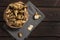 Several Jerusalem artichoke tubers in a paper bag on a wooden table with copy space. Helianthus tuberosus. Top view