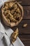 Several Jerusalem artichoke tubers in a paper bag on a wooden table with copy space. Helianthus tuberosus. Top view. Vertical