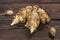 Several Jerusalem artichoke tubers on a wooden table. Helianthus tuberosus. Close up