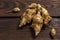 Several Jerusalem artichoke tubers on a wooden table. Helianthus tuberosus. Close up