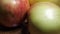 Several large apples in close-up. 4k macro video, soft focus. Fruit rotation