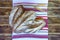 Several loaves of rye bread on a towel with Ukrainian ornaments. Selective focus, horizontal photo.