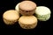 Several macaroons on a black background