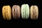 Several macaroons on a black background