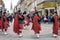 Several men dressed with typical Scottish kilts playing the highland bagpipes through the streets of Inverness, Highlands.