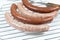 Several merguez and sausage on a white background