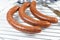 Several merguez on a white background