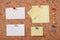 Several message papers pinned to cork board