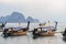 Several moored thai traditional long-tail boat in the sea water near the