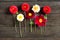 Several multi-colored dahlia flowers on a wooden background