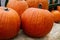 Several Orange Pumpkins Sitting On Bales Of Hay