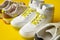 Several pairs of fashion trendy sport shoes on yellow background