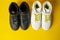 Several pairs of fashion trendy sport shoes on yellow background