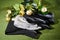 Several pairs of new male cotton socks on a green surface and flowers background. The concept of coziness and comfort. Gift to a