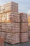 Several pallets with concrete brick stacked on top of each other in depot. Industrial production of bricks. vertical photo
