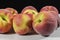 Several peaches on clear and rough surface and black background