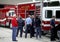 Several people examine some Fire trucks