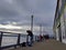 Several people fishing and viewing the landscape from the Pier 54 docks